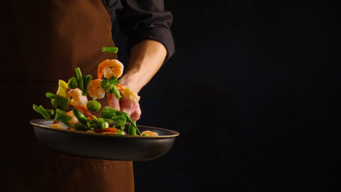 Close-up.,The,Chef,Cooks,Assorted,Shrimp,,Vegetables,And,Herbs,In